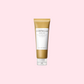 Produktbild av SKIN1004 Madagascar Centella Ampoule Foam i en 125 ml tub. Förpackningen är guldig med vit etikett och text i svart, stående mot en ljusrosa bakgrund.